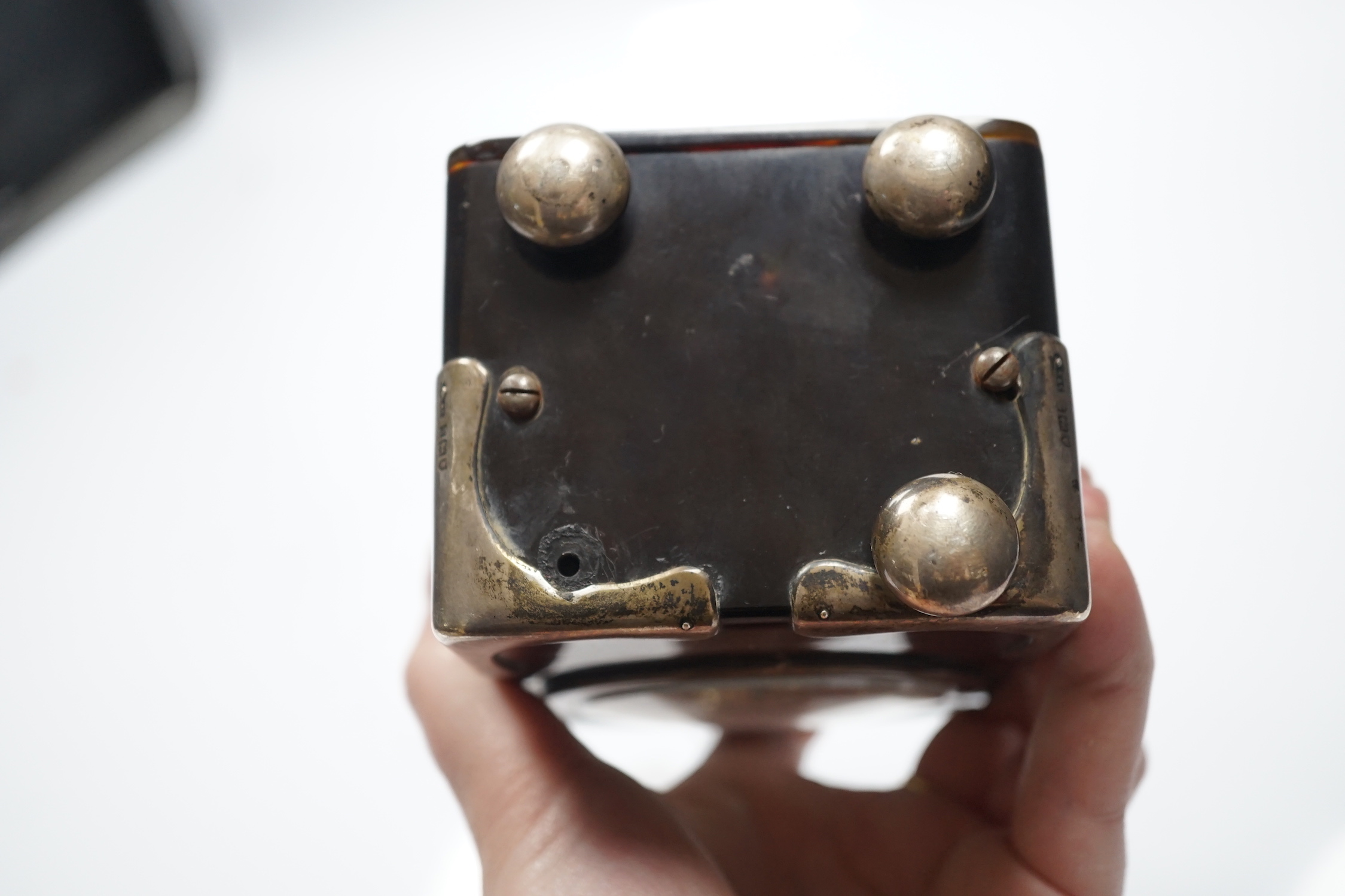 A George V silver mounted tortoiseshell cased carriage clock, with Arabic dial, chips to the case and ball foot missing, height 15cm over handle.